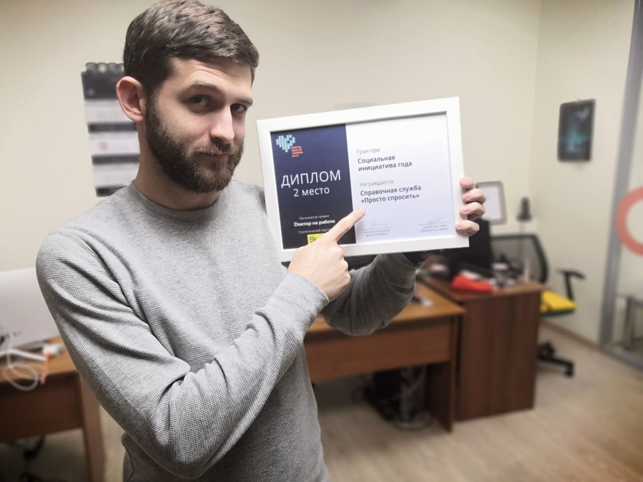 Alex holding the Digital Health Awards 2019 diploma: Grand Prix, Social Initiative of the Year, second place, awarded to the Prosto Sprosit reference service.